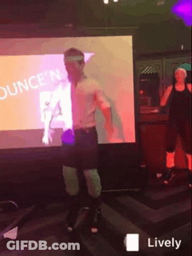 A Man Is Dancing In Front Of A Screen That Says Ounce 'N GIF