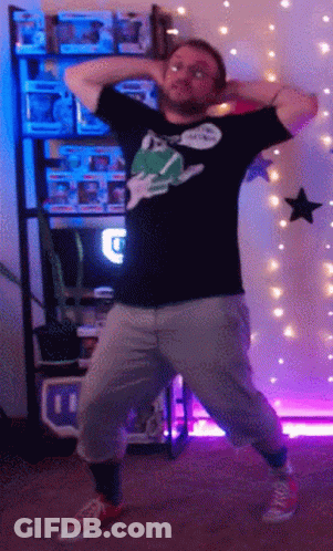 A Man Is Dancing In Front Of A Shelf Full Of Funko Pops GIF