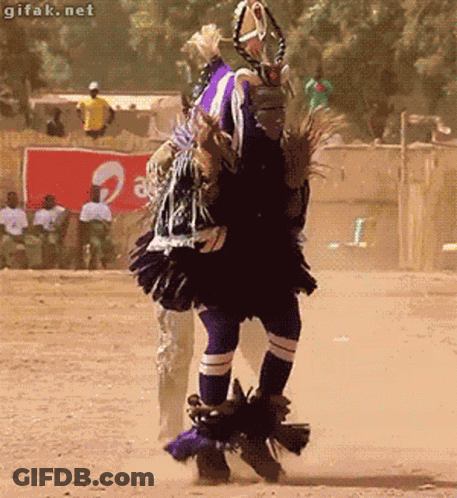 A Man Is Dancing In Front Of A Sign That Says ' Gifak.net ' On It GIF