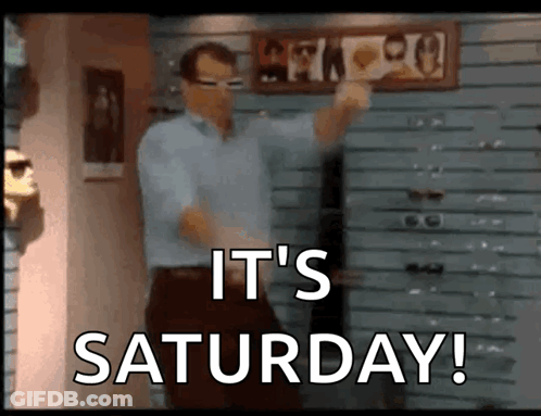 A Man Is Dancing In Front Of A Sign That Says " It 'S Saturday " GIF