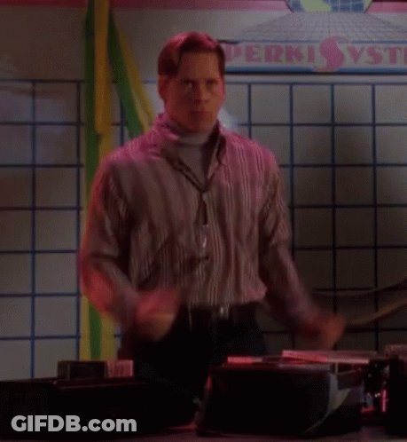 A Man Is Dancing In Front Of A Sign That Says Perki GIF