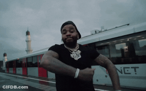 A Man Is Dancing In Front Of A Train That Has The Word Net On It GIF