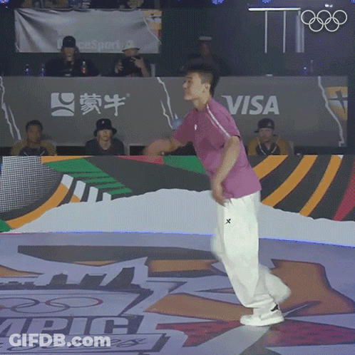 A Man Is Dancing In Front Of A Visa Banner GIF