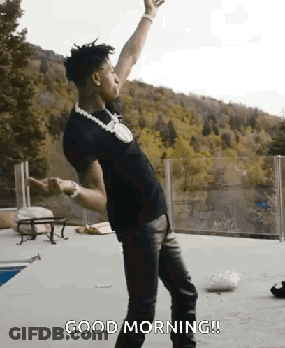 A Man Is Dancing On A Patio With His Arms In The Air And Says `` Good Morning '' . GIF