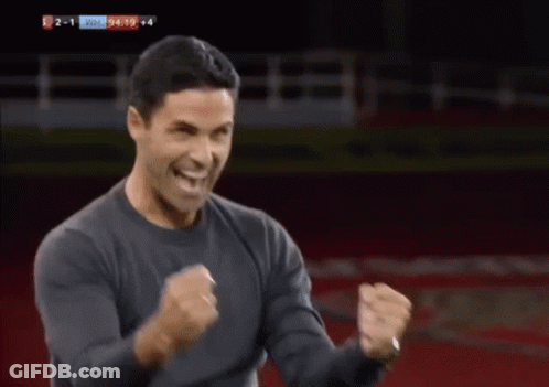 A Man Is Dancing On A Soccer Field In Front Of A Sign That Says Fly Emirates To The Far East GIF