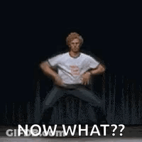A Man Is Dancing On A Stage And Says `` Now What ? '' . GIF