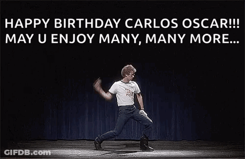 A Man Is Dancing On A Stage In Front Of A Black Background . GIF