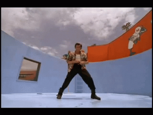 A Man Is Dancing On A Stage In Front Of A Wall With A Baseball Player On It . GIF