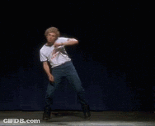 A Man Is Dancing On A Stage With A Shirt That Says ' I 'M A Loser ' On It GIF