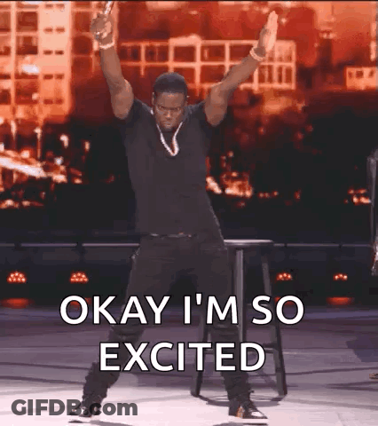 A Man Is Dancing On A Stage With The Words Okay I 'M So Excited Above Him GIF