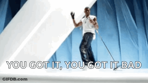 A Man Is Dancing On A Stage With The Words `` You Got It , You Got It Bad '' Behind Him . GIF