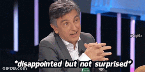 A Man Is Disappointed But Not Surprised While Sitting At A Table With His Hands Folded GIF