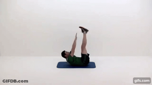 A Man Is Doing A Crunch On A Mat With His Legs Up . GIF