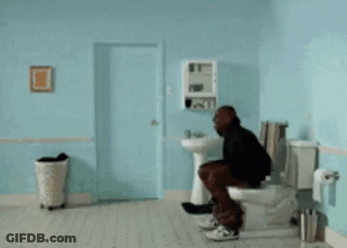 A Man Is Doing A Handstand In A Bathroom With A Sink And Toilet GIF