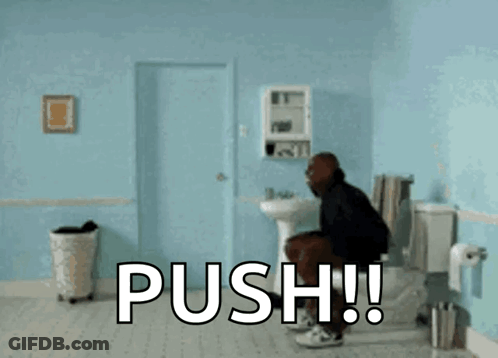 A Man Is Doing A Handstand In A Bathroom With The Word Push Written On The Floor GIF