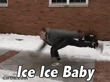 A Man Is Doing A Handstand On Ice In Front Of A Building . GIF