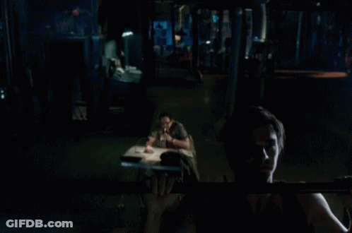 A Man Is Doing A Pull Up In The Dark GIF