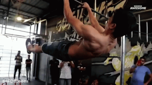A Man Is Doing A Pull Up On A Bar In A Gym With The Words Awesome Written On The Bottom GIF