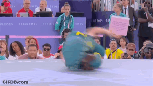 A Man Is Doing A Trick In Front Of A Crowd At The Paris 2024 Games GIF