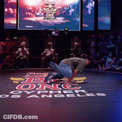 A Man Is Doing A Trick In Front Of A Sign That Says Red Bull Bc One Oypher Los Angeles GIF