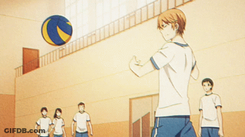 A Man Is Doing A Trick With A Volleyball In A Gym GIF
