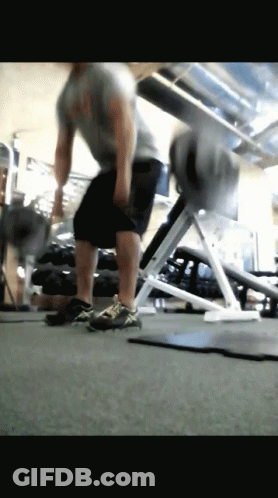 A Man Is Doing Exercises In A Gym GIF
