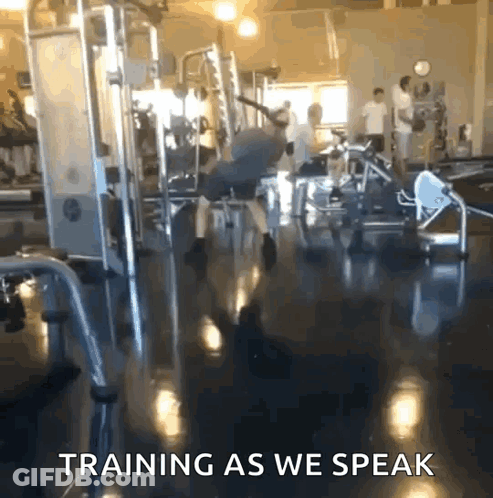 A Man Is Doing Exercises In A Gym With The Words Training As We Speak GIF