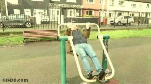 Man Exercising In Park Front Of Building GIF