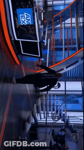 A Man Is Doing Push Ups In Front Of A News Desk That Says Am Ex GIF