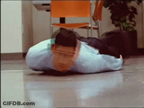 A Man Is Doing Push Ups On The Floor In A Room . GIF