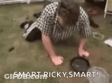 A Man Is Doing Push Ups On The Floor While A Dog Looks On . GIF