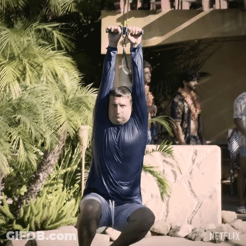 A Man Is Doing Squats In Front Of A Netflix Logo GIF
