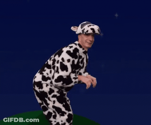A Man Is Dressed In A Cow Costume And Hat GIF