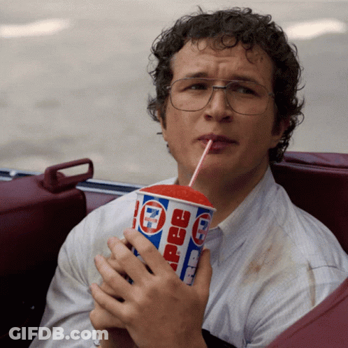 A Man Is Drinking A 7 Eleven Pepsi Through A Straw GIF