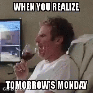 A Man Is Drinking A Glass Of Wine While Sitting In A Chair In Front Of A Computer Screen . GIF