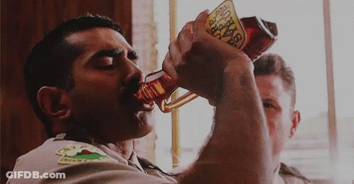 A Man Is Drinking From A Bottle That Says Busch GIF