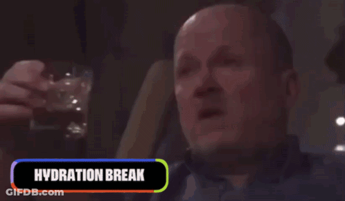 A Man Is Drinking From A Bottle With The Words Hydration Break Behind Him GIF
