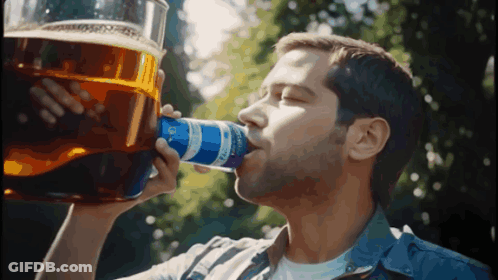 A Man Is Drinking From A Can That Says Bud Light On It GIF