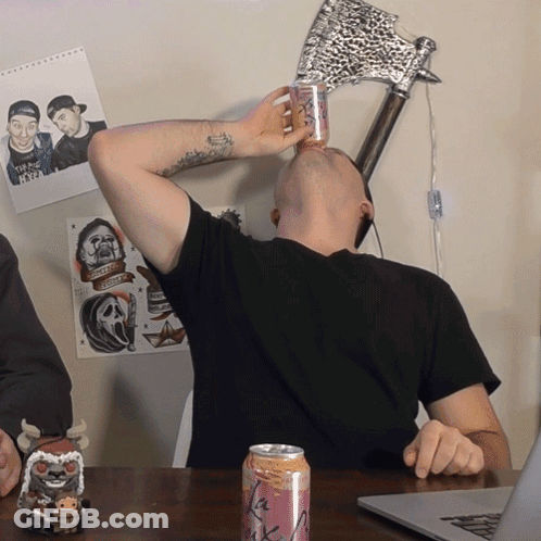 A Man Is Drinking From A Can That Says La Rock GIF