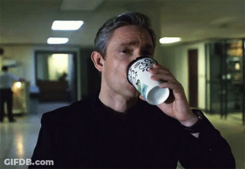 A Man Is Drinking From A Cup That Says Coffee GIF