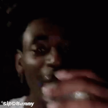 A Man Is Drinking From A Glass In A Close Up Of His Face . GIF