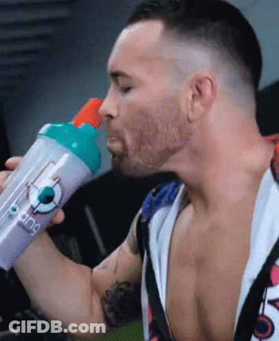 A Man Is Drinking From A Purple Bottle That Says ' King ' On It GIF