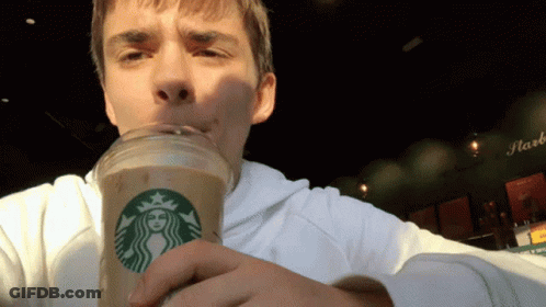 A Man Is Drinking From A Starbucks Cup With A Woman On It GIF