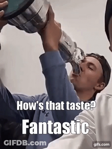 A Man Is Drinking From A Trophy With A Caption That Says How 'S That Taste Fantastic GIF