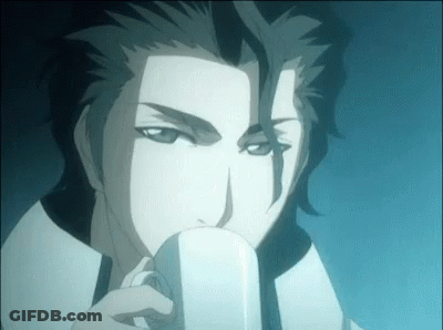 A Man Is Drinking From A White Cup . GIF