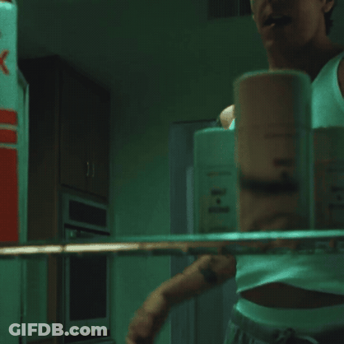 A Man Is Drinking Milk From A Carton That Says S On It GIF
