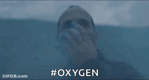 A Man Is Drinking Oxygen From A Bottle While Swimming In The Water . GIF