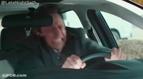 A Man Is Driving A Car And Making A Face . GIF