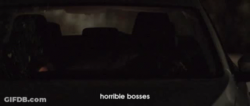 A Man Is Driving A Car At Night With Horrible Bosses Written On The Bottom Of The Screen GIF