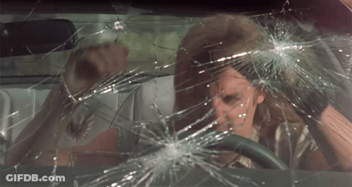 A Man Is Driving A Car With A Broken Windshield GIF